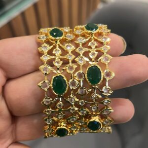 Traditional Green Jadau Bangles with vibrant gemstones.