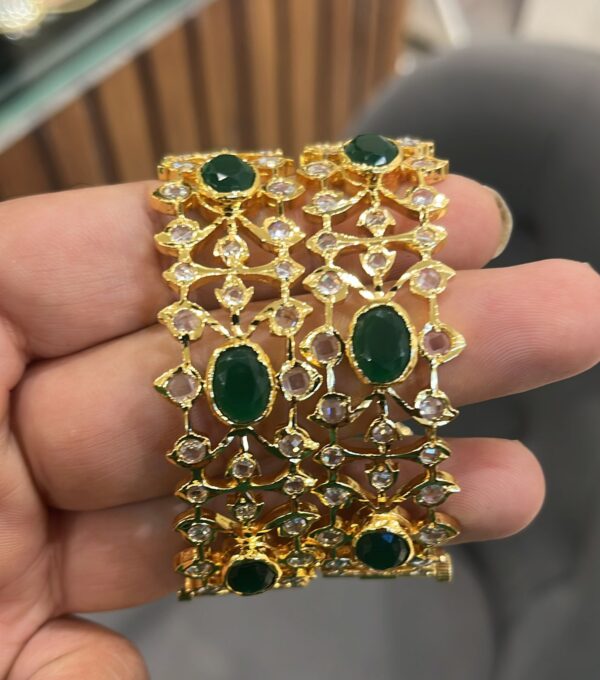 Traditional Green Jadau Bangles with vibrant gemstones.