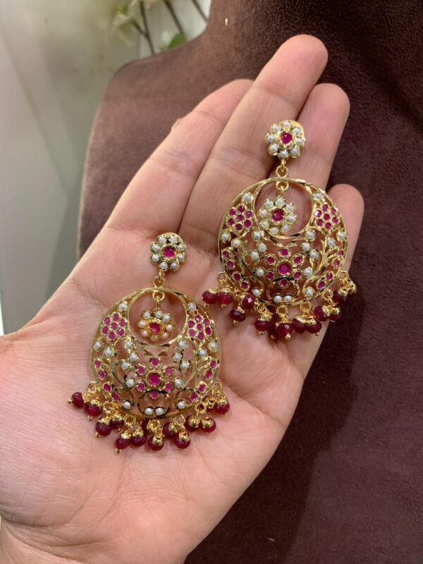 Exquisite Jadau Chandbali Earrings with intricate pearl and semi-precious stonework.