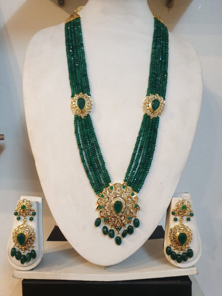 Handcrafted Green Rani Haar Set adorned with semi-precious pearls and gold-tone detailing.